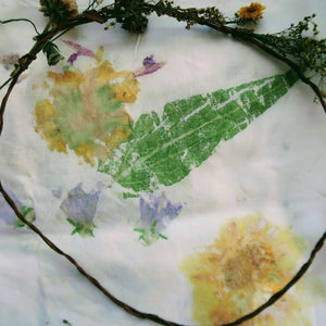 Fabric dyeing cloth with vine and flowers wrapped around it