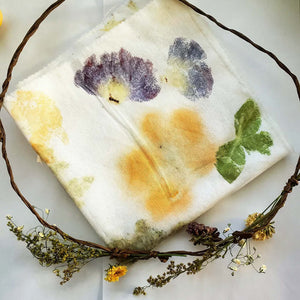 Fabric dyeing cloth with vine and flowers wrapped around it.
